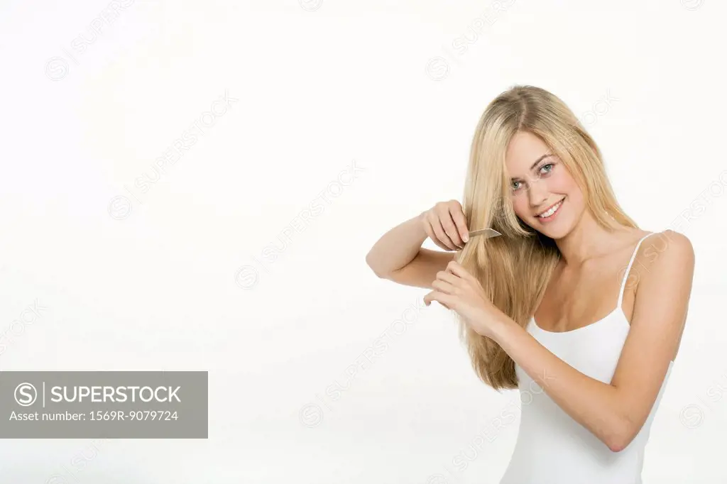Teen girl combing her hair