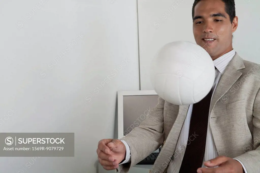 Man playing with ball in office