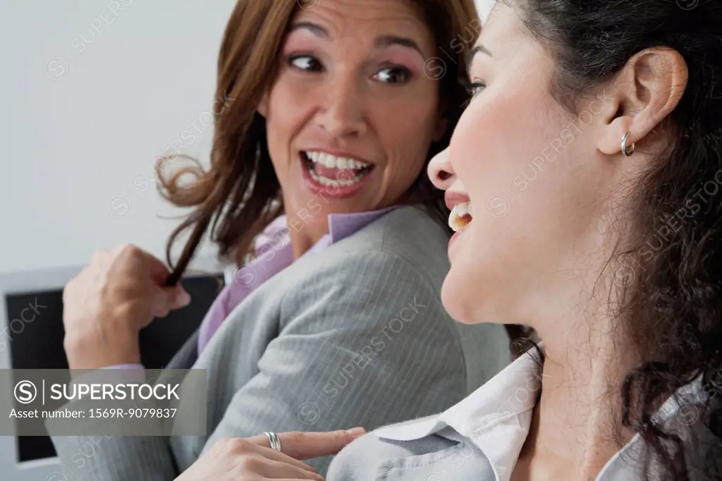 Female coworkers chatting in office