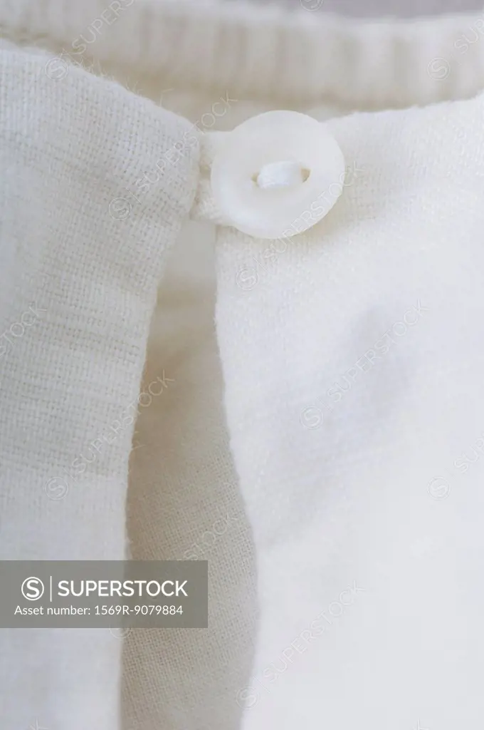 Close_up of button closure on clothing