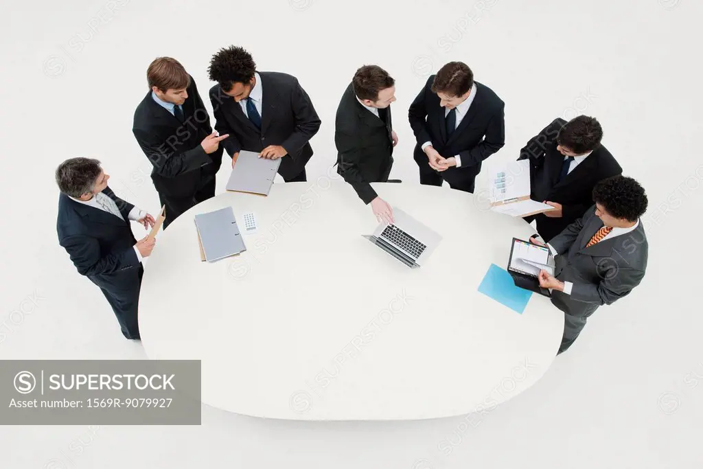 Business associates working together in pairs around table