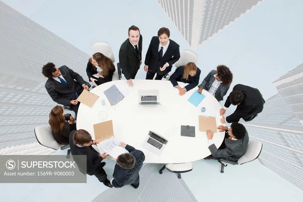 Business executives meeting on top of superimposed image of skyscrapers