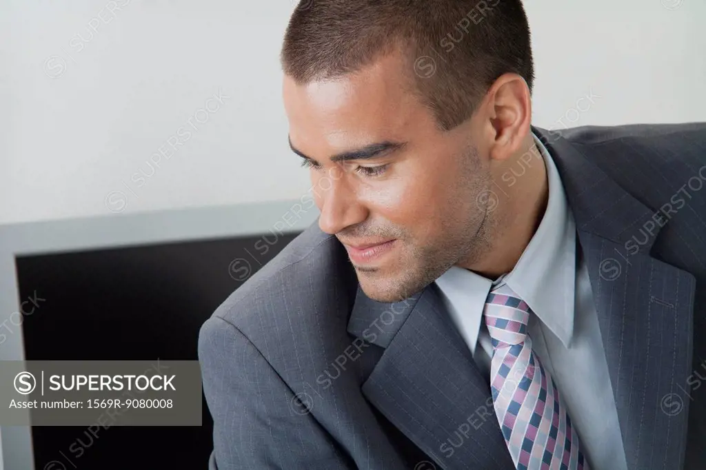Young businessman looking away in thought