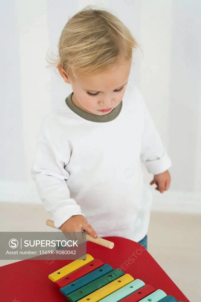 Baby boy playing with toy xylophone