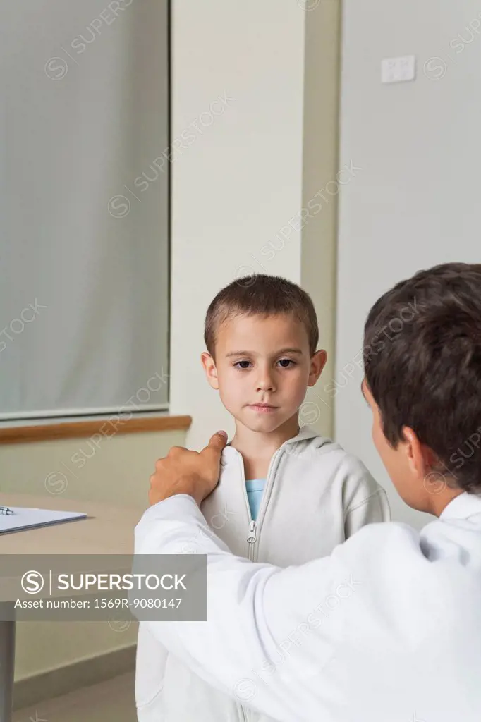 Doctor comforting little boy