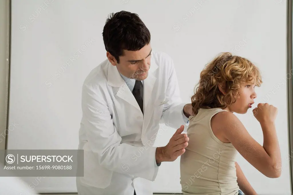 Doctor checking young patient´s cough