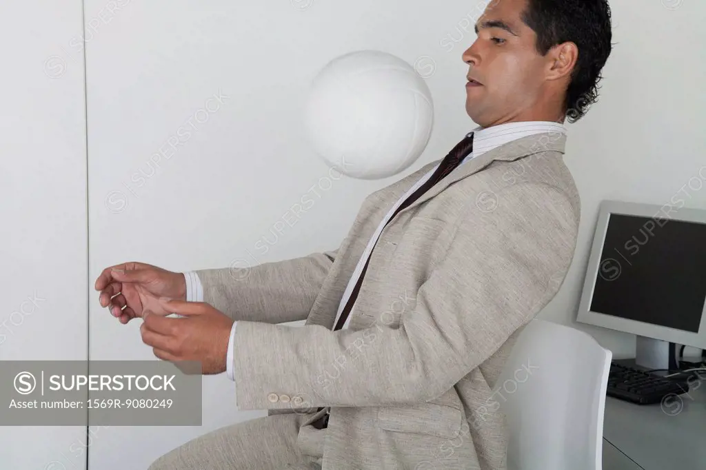 Man playing with ball in office