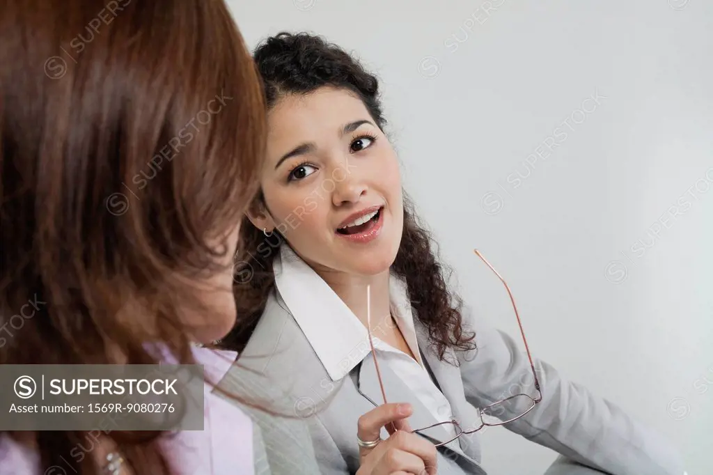 Female colleagues talking together in office