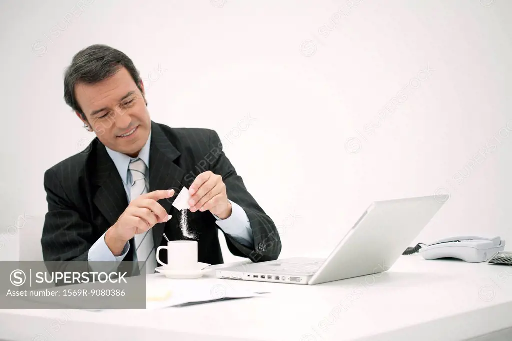 Businessman taking a coffee break at desk