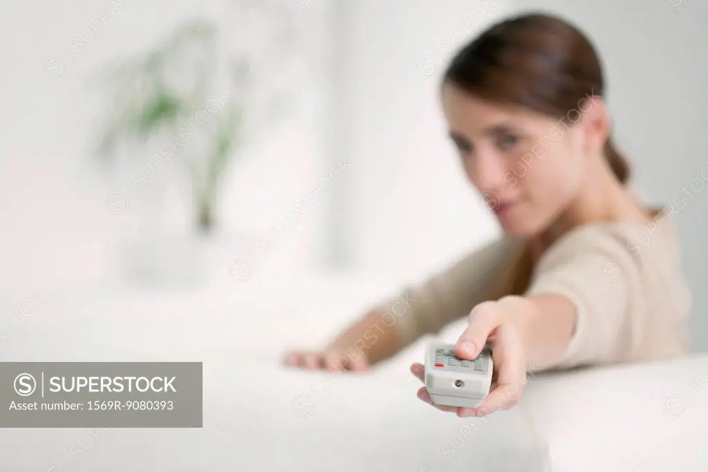 Woman holding out remote control