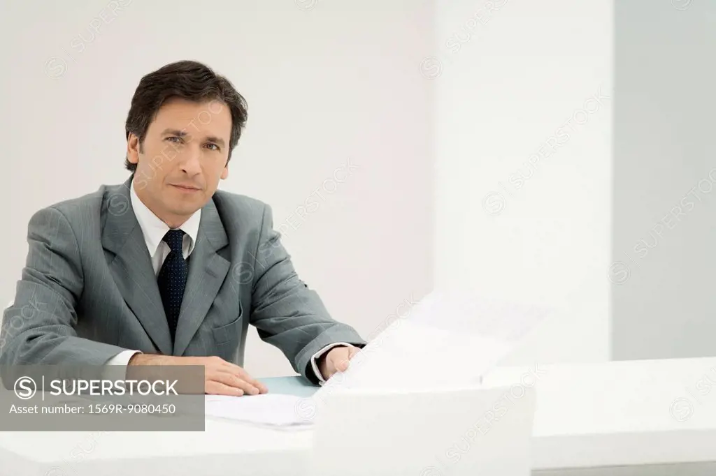 Business executive reviewing documents, portrait