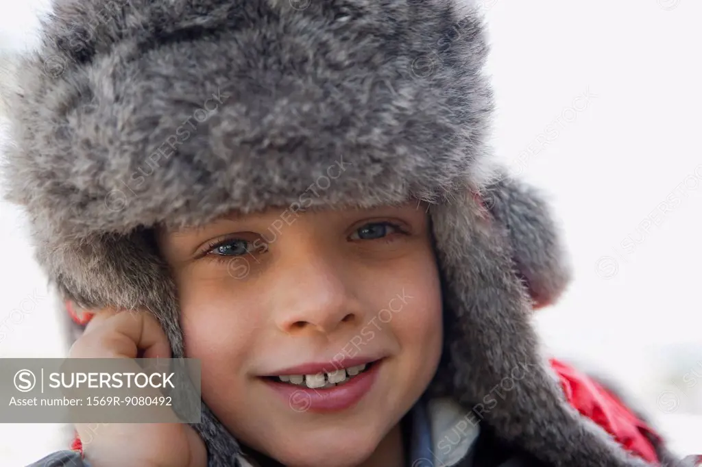 Boy wearing trappers hat, portrait, close_up