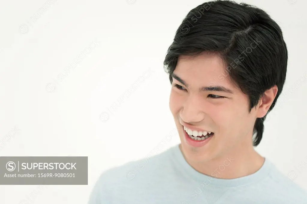 Young man laughing, portrait