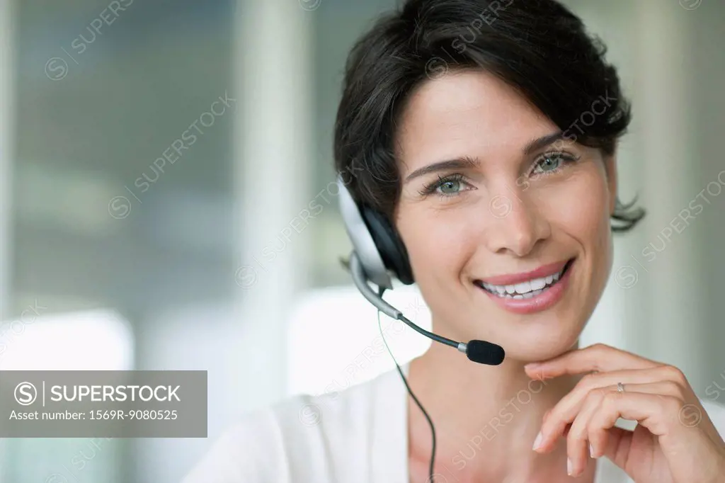 Woman using headset, smiling cheerfully