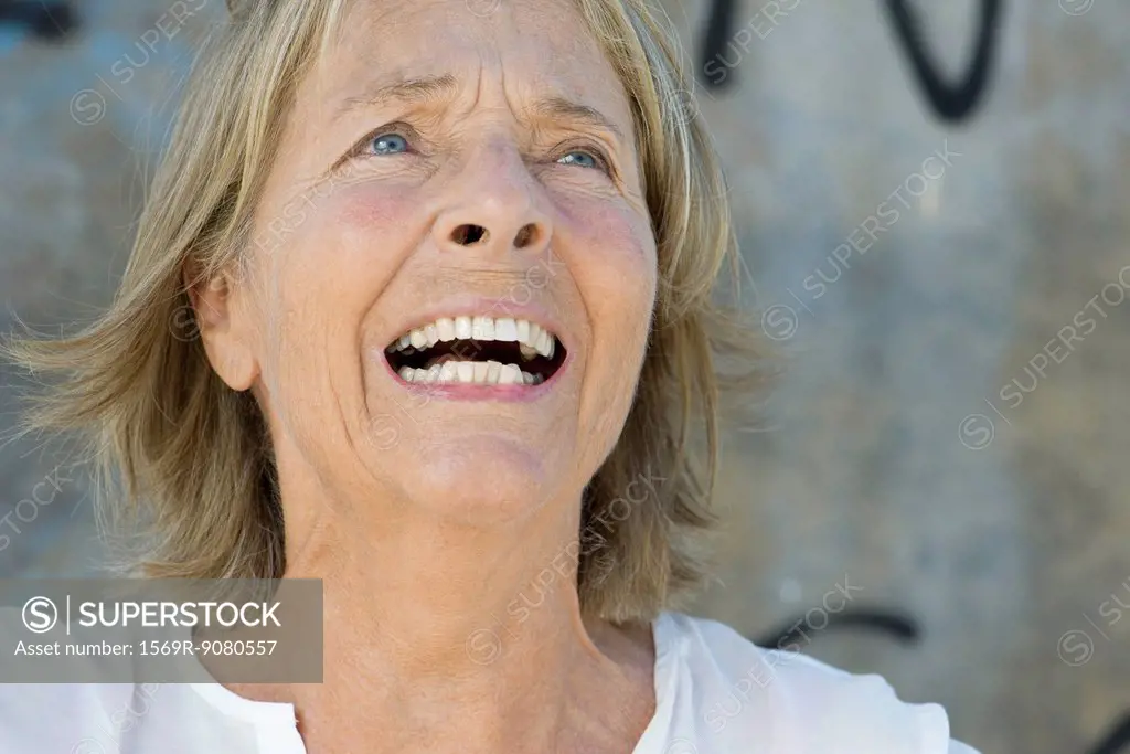 Senior woman with anguished expression on face