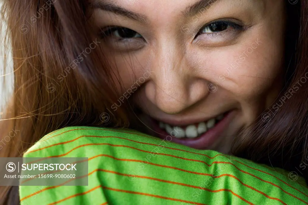 Young woman smiling cheerfully, portrait