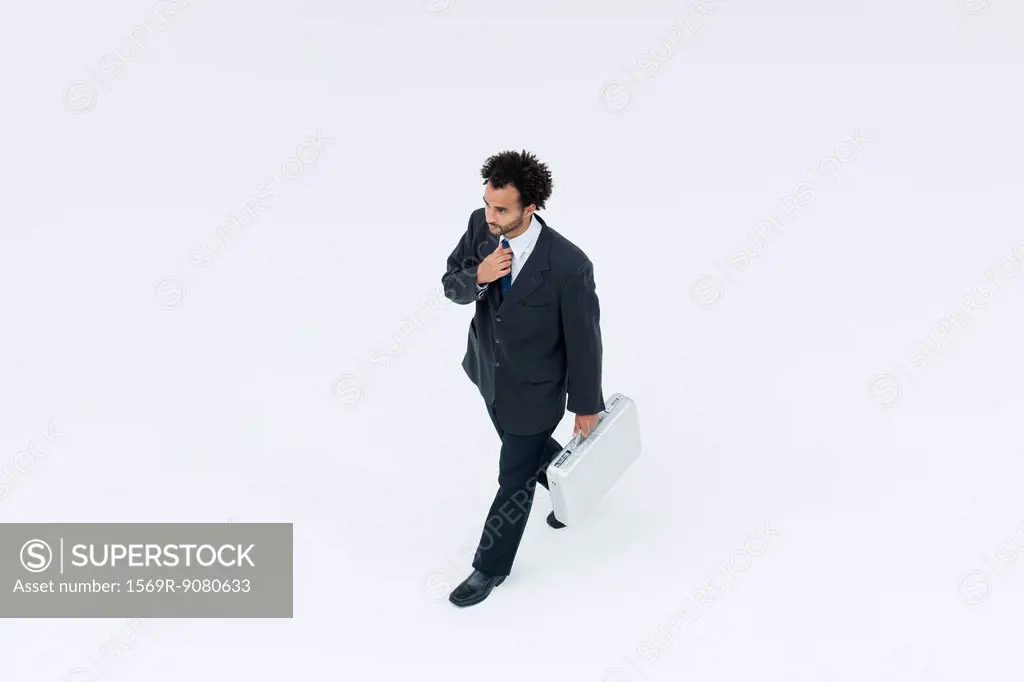 Businessman adjusting tie while on the move