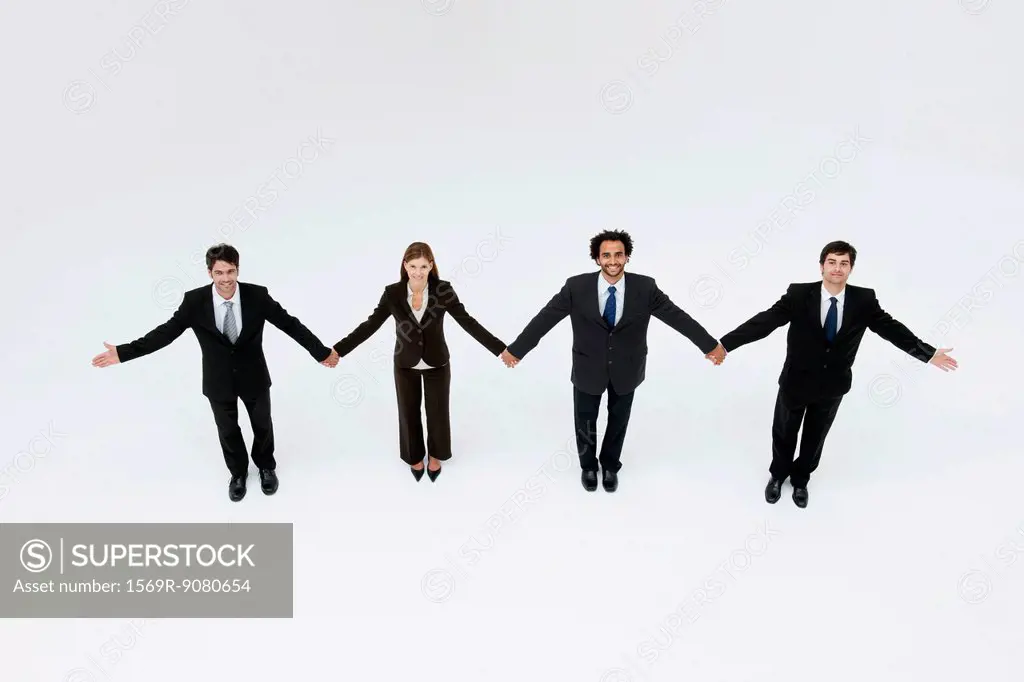 Business associates holding hands, elevated view