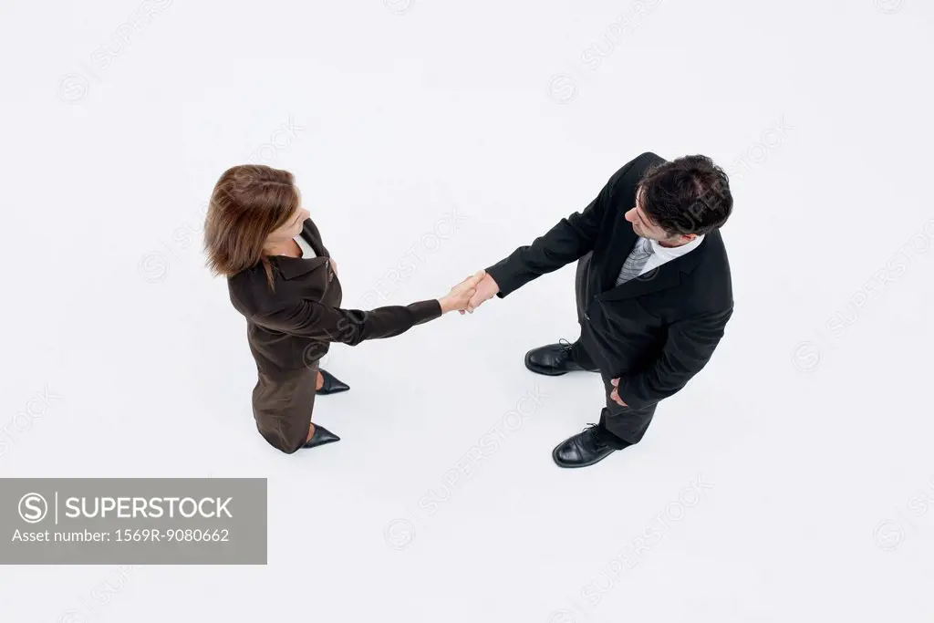 Business associates shaking hands, overhead view