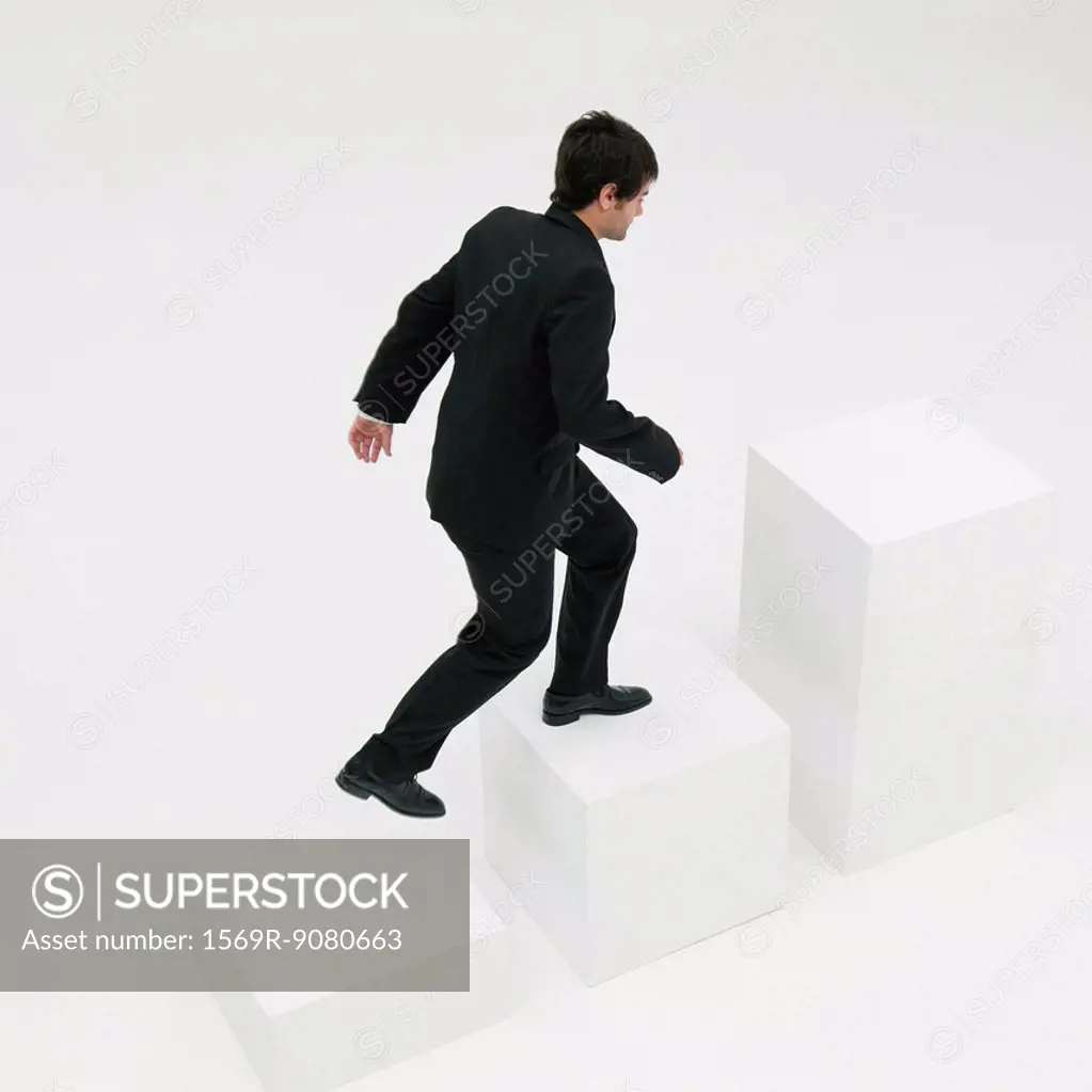 Businessman ascending steps