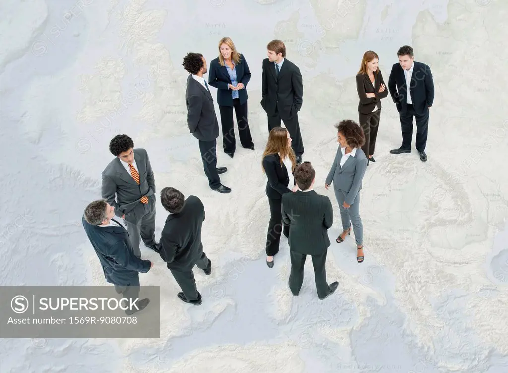 Executives chatting while standing on map of Europe