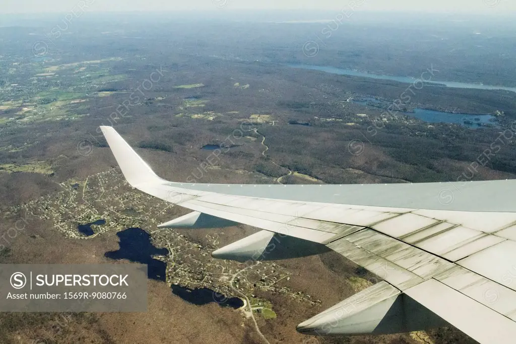 Focus on an airplane wing, flying united states
