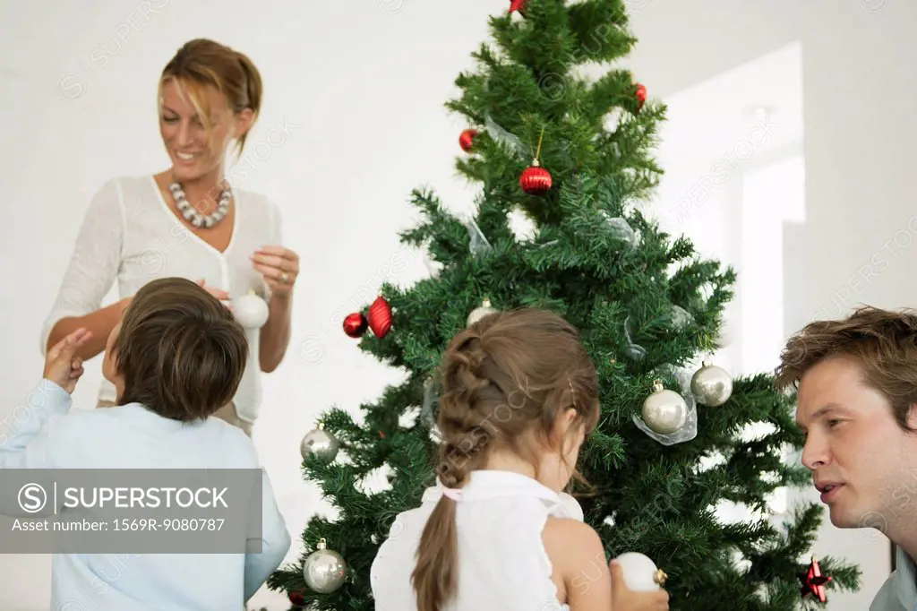 Family decorating Christmas tree together