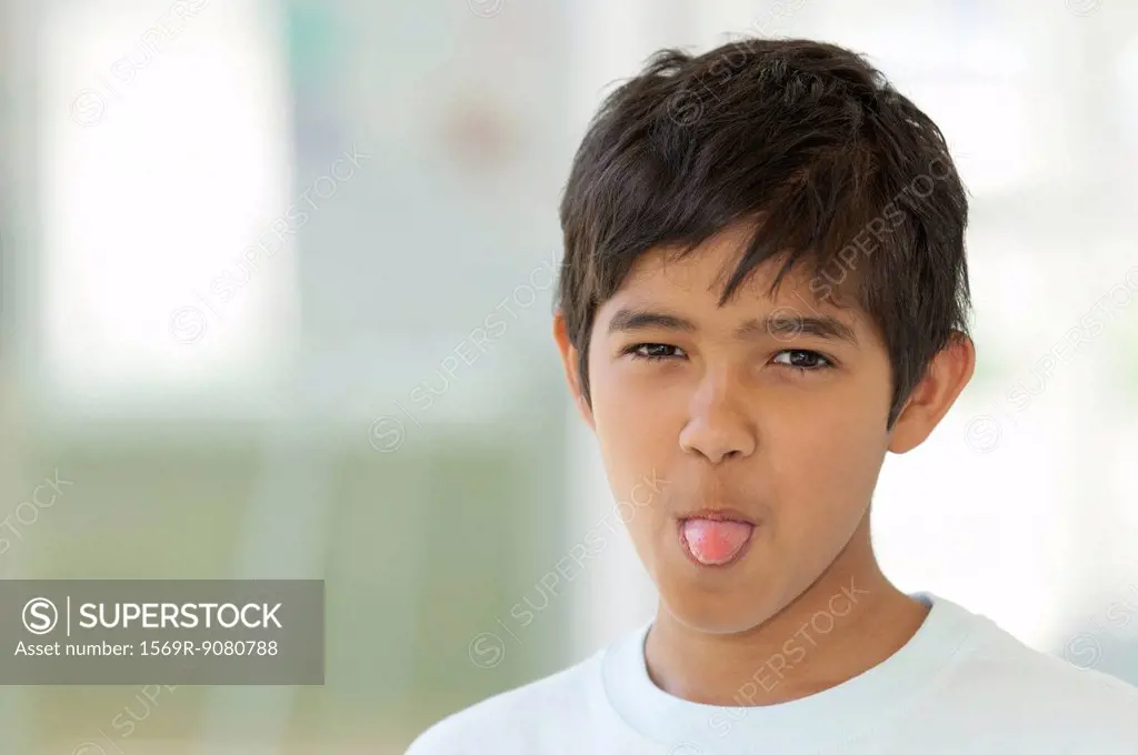 Boy sticking out tongue, portrait