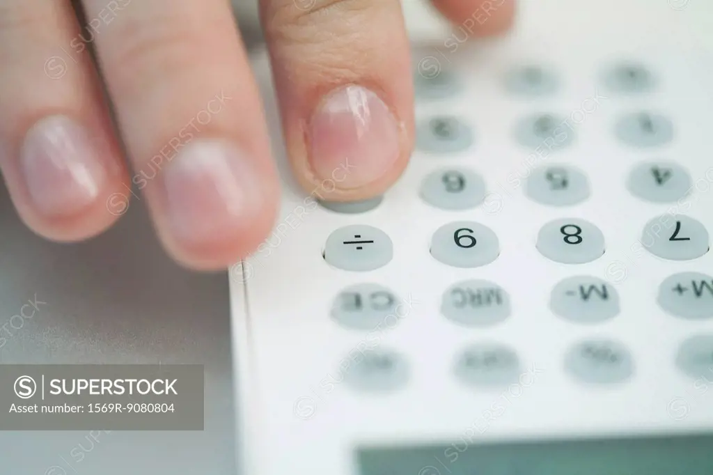Woman using calculator, extreme close_up