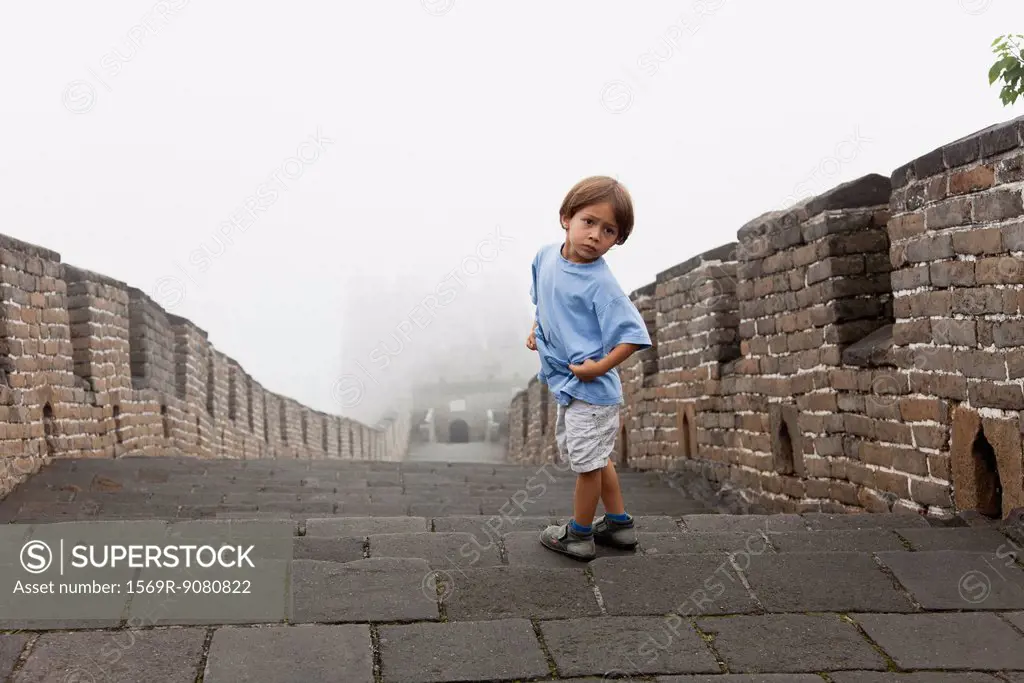 Boy looking over shoulder, Great Wall, China