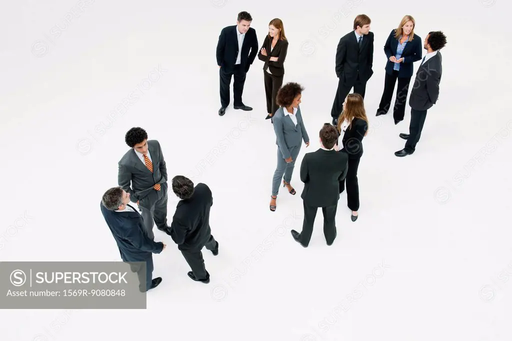 Business associates standing in small groups chatting