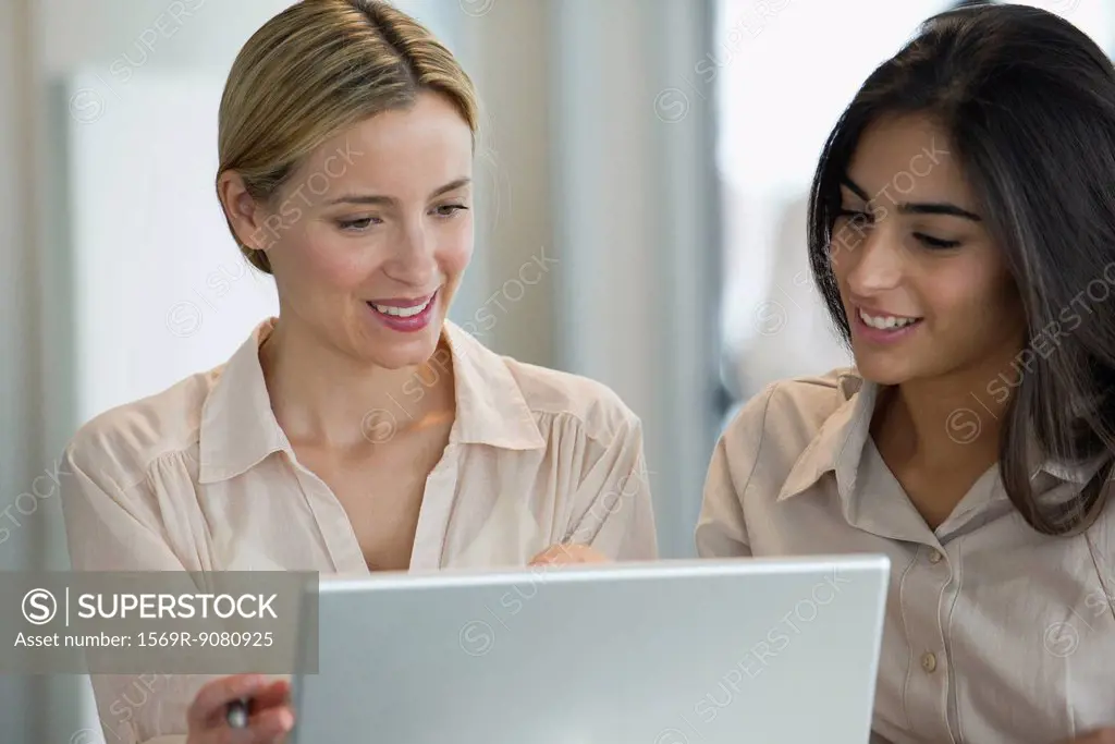 Women working together with laptop computer