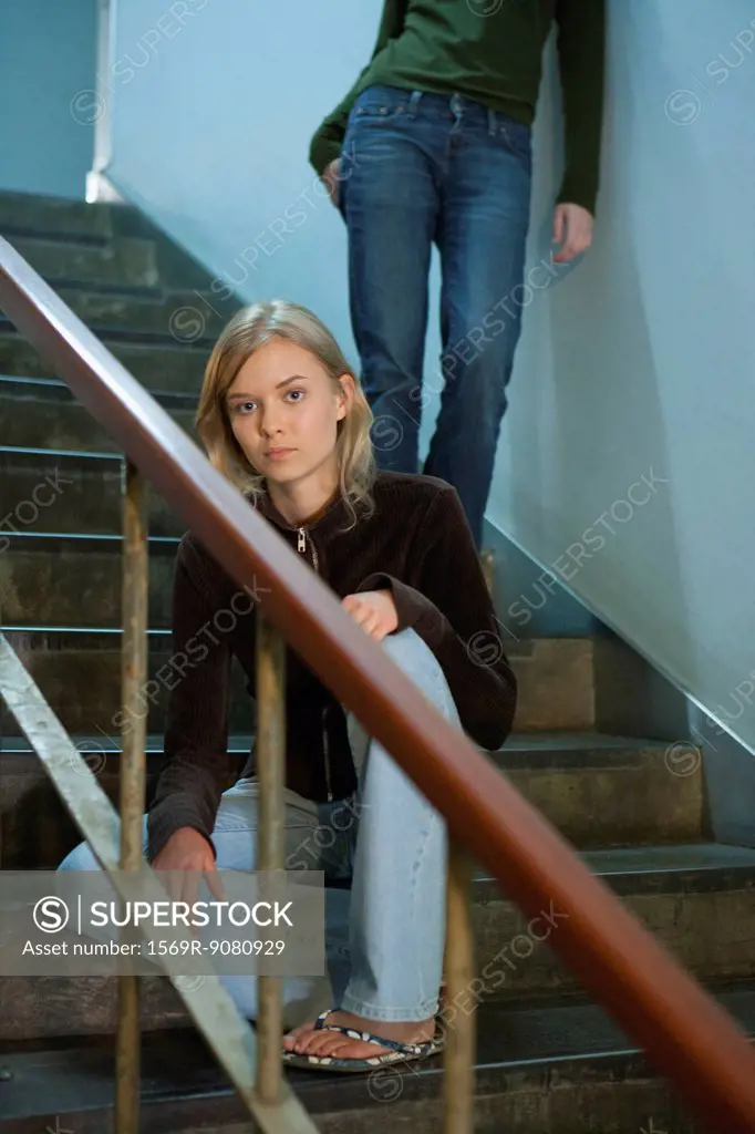 Teenage girl sitting on stairs