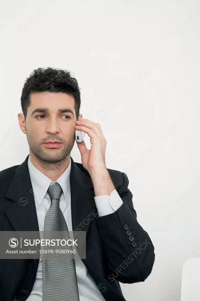 Mid-adult businessman talking on cell phone