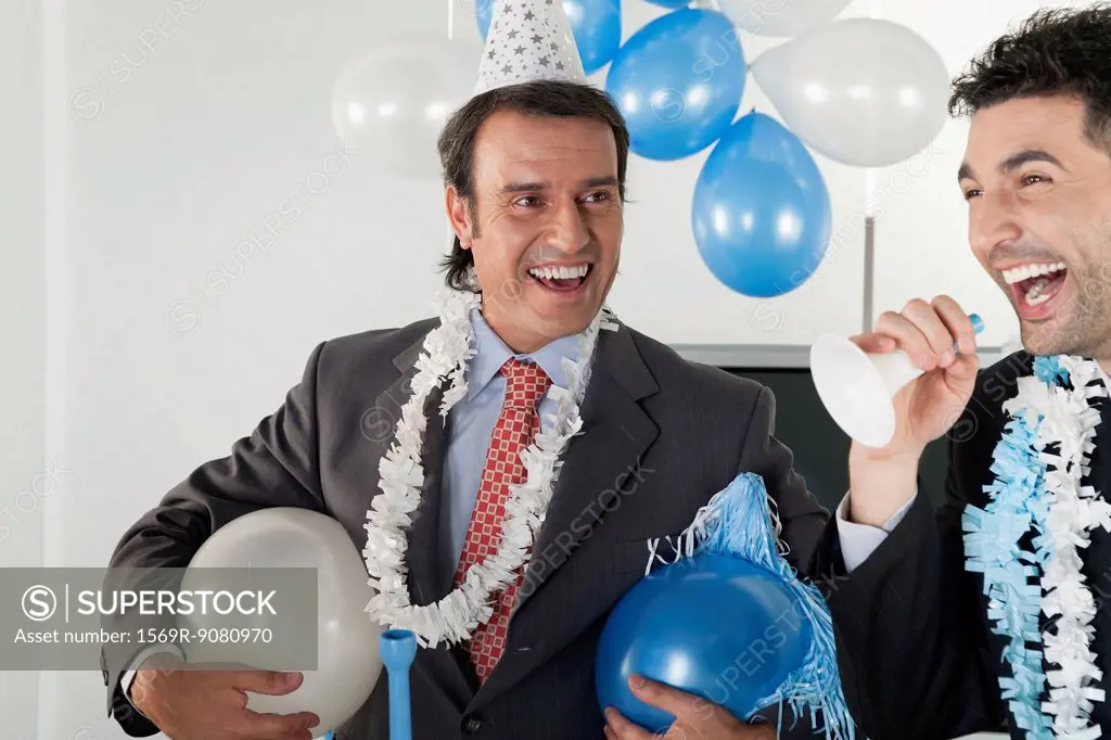Businessmen having fun in office party