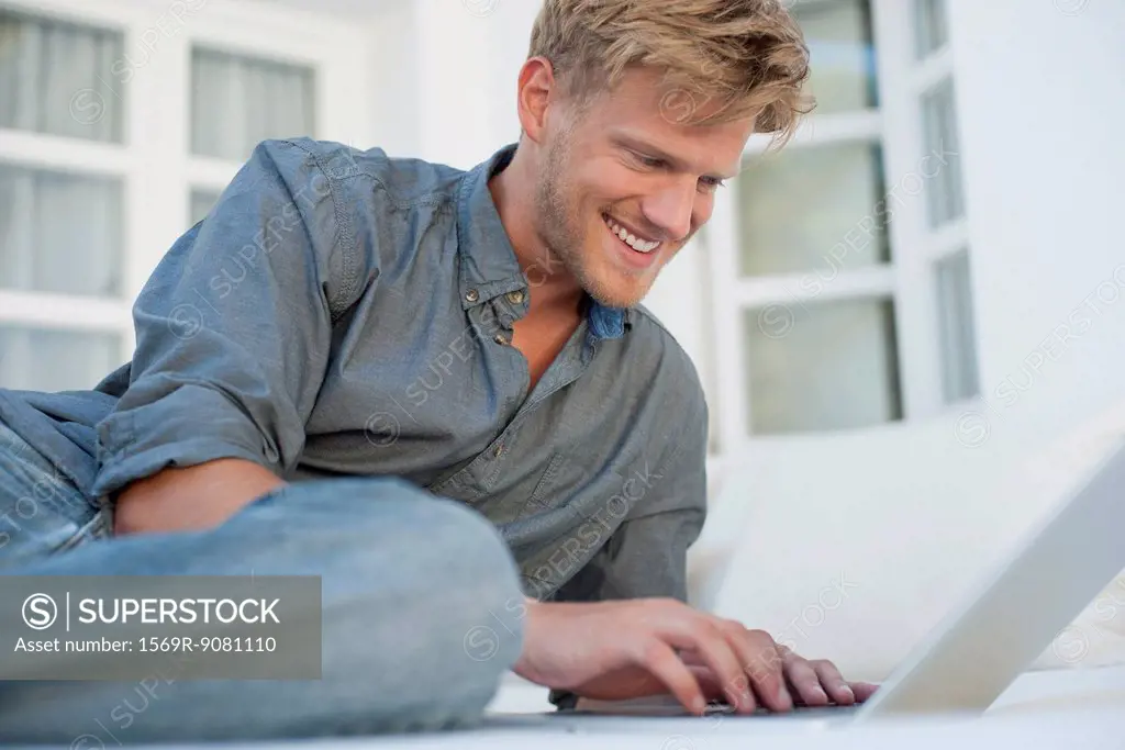 Young man using laptop computer outdoors