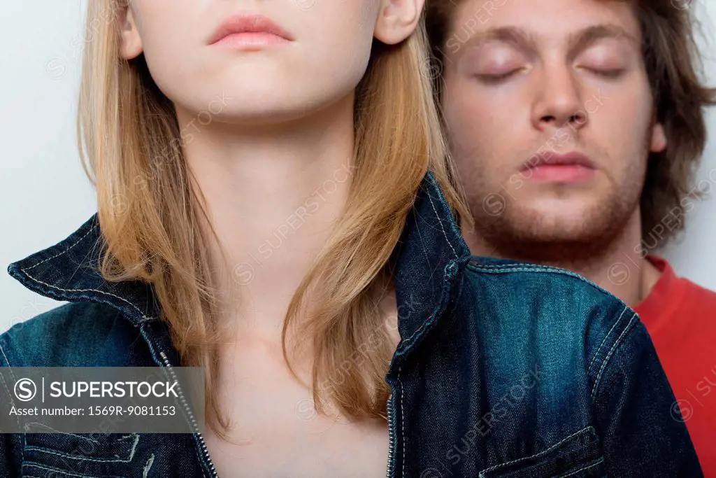 Young couple, man's eyes closed