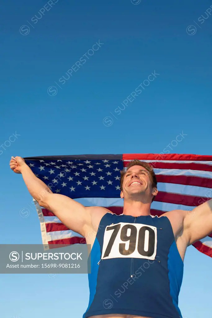 Male athlete holding up American flag