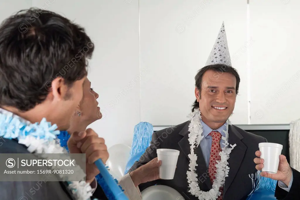 Office celebration, mature man looking at camera