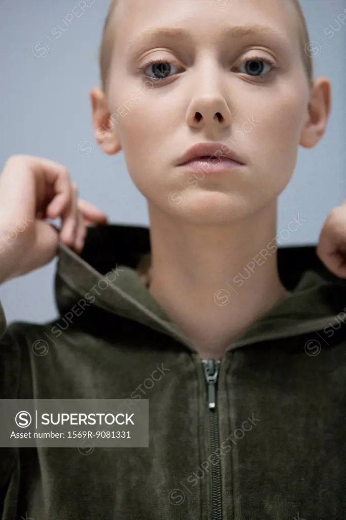 Young woman wearing hooded sweatshirt, portrait