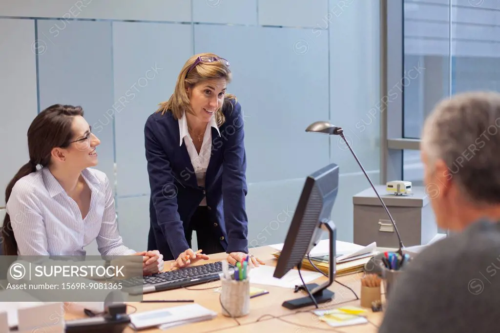 Businesswoman talking with colleagues in office
