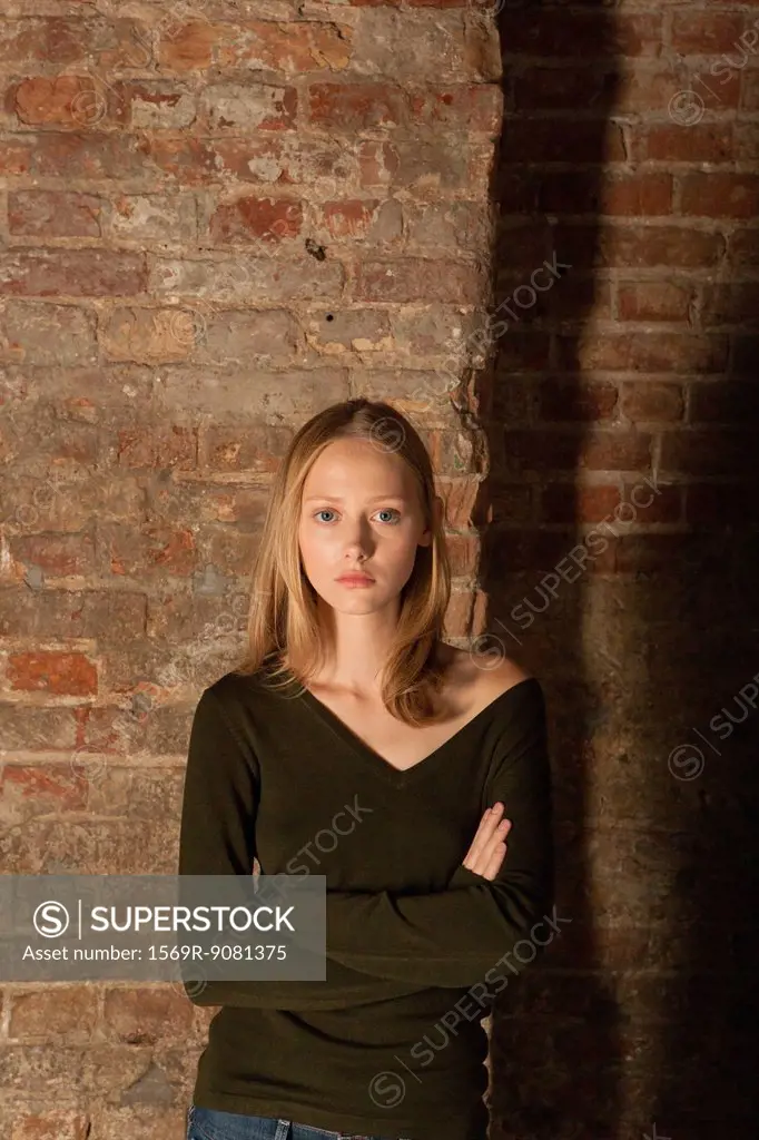 Young woman with arms folded, portrait