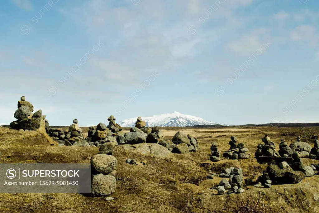 Cairns volcanic stone on a background of snowy mountains, Iceland Gullfoss