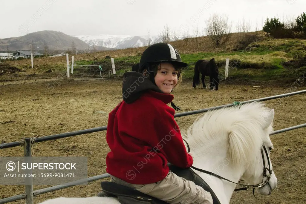 Smiling boy on a Icelandic horse, Iceland