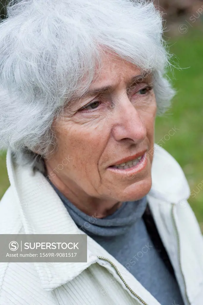 Senior woman looking away in thought, portrait