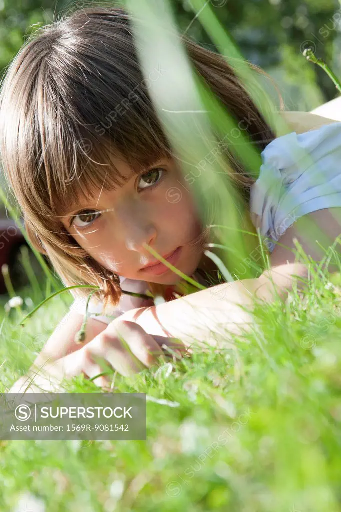 Girl lying in grass, portrait