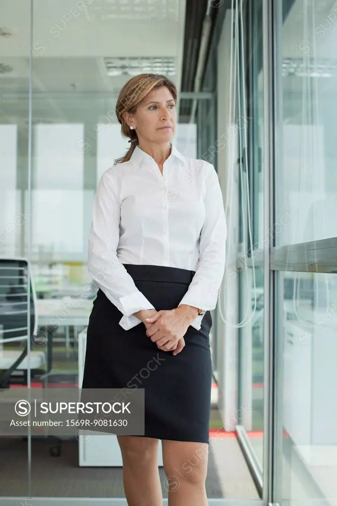 Mature businesswoman looking out window