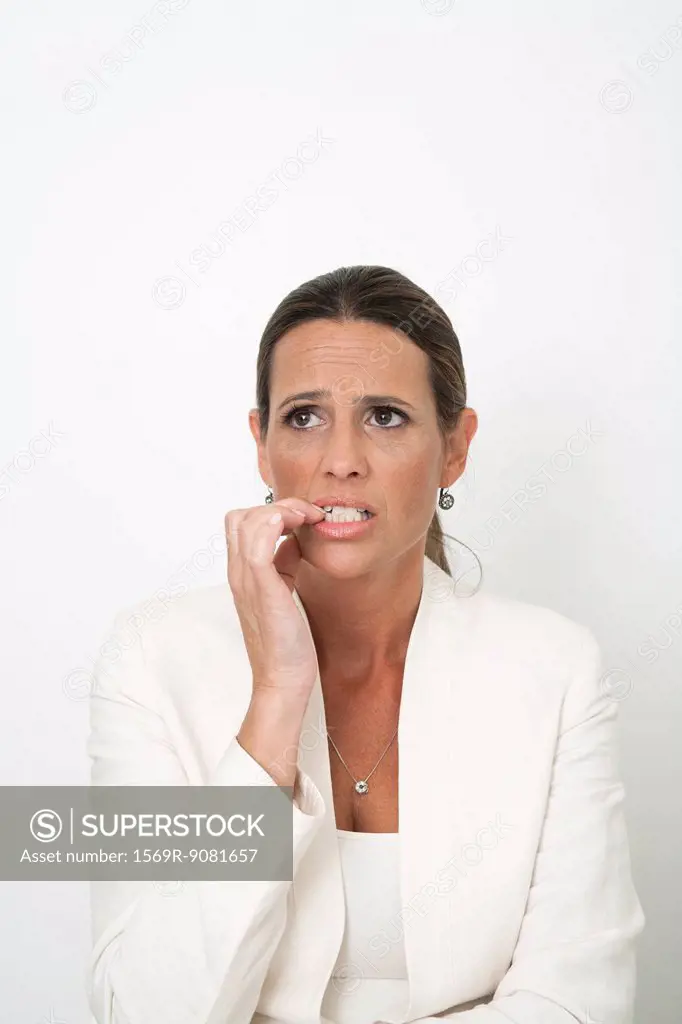 Mature businesswoman biting nails