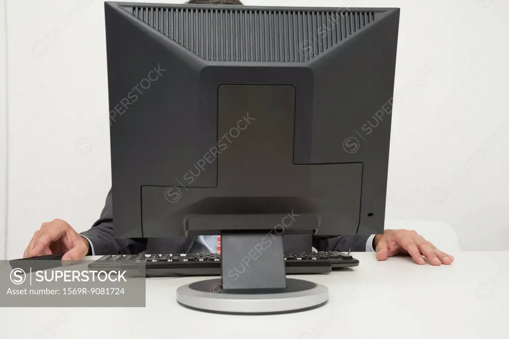 Man sitting in front of computer monitor