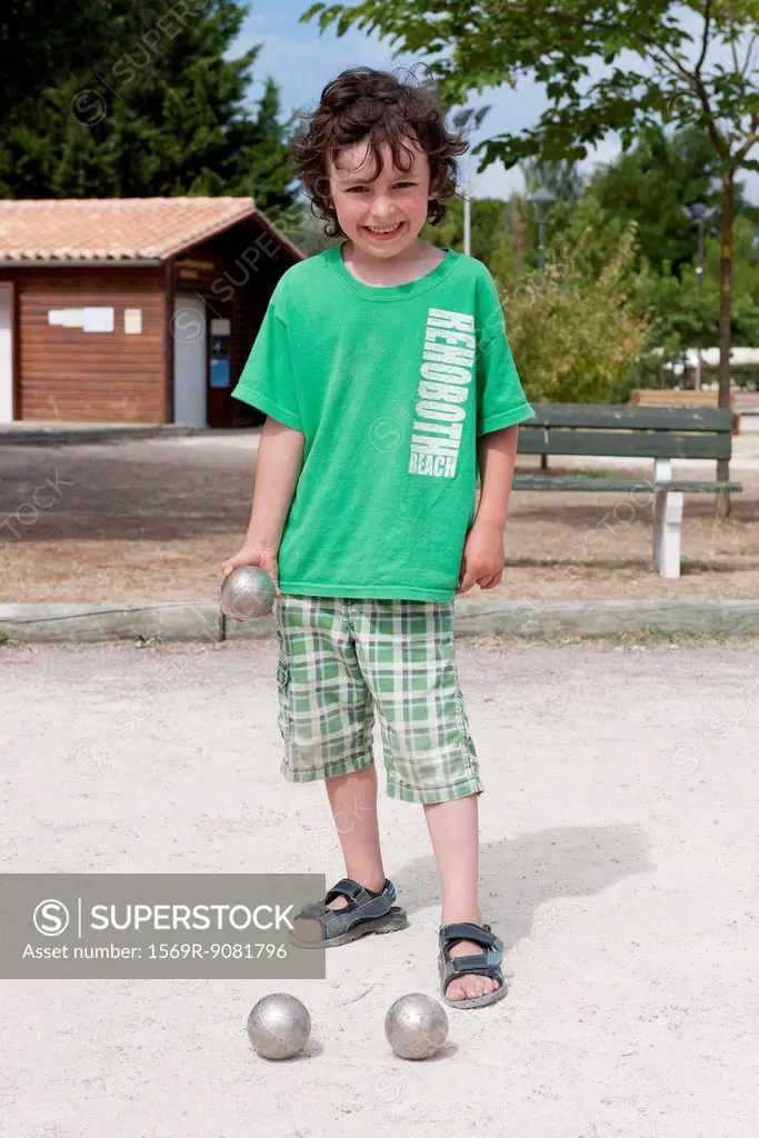 Boy playing bocce ball